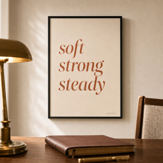 Soft Strong Steady Poster — Stacked 'soft strong steady' italic terracotta feminine, lifestyle in interior, Atelier Poster