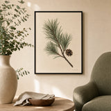Pine Branch Winter Poster — Single pine branch with one small pinecone on cream, lifestyle in interior, Atelier Poster